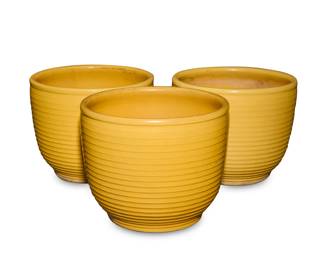 1009 Three Bauer yellow glazed pottery ringware planters Circa 1930s Each incised to underside: 111 3 pieces Each: 13.25" H x 16.375" Dia. Estimate: $500 - $700