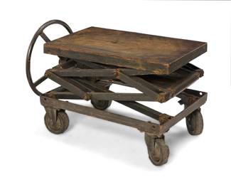 1098 An industrial scissor lift table Early 20th century Elevated by turning the wheel at side, raised on rubber casters Lowest: 21" H x 38" W x 23.75" D Estimate: $500 - $700