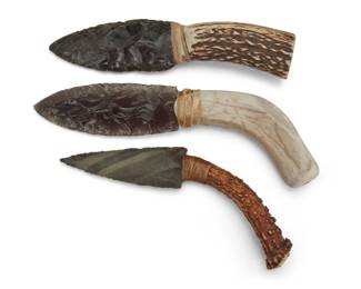 1390 A group of Native American antler and stone knives Late 20th century Three works:  Attributed to George Blake (b. 1944, Hupa-Yurok) A Hupa obsidian and carved antler knife, circa 1990 Unmarked With a knapped black obsidian blade attached to an antler handle with sinew wrapping 8.25" H x 2" W  Two Native American antler and knapped stone knives Largest with oval artist's cipher to handle base Comprising two knives, one with a knapped obsidian blade, and onewith a grey stone blade, each with an antler handle of varying size and color, with sinew or hide wrappings 2 pieces Larger: 9.5" H x 1.75" W; Smaller: 8" H x 1.5" W  3 pieces total Estimate: $200 - $400