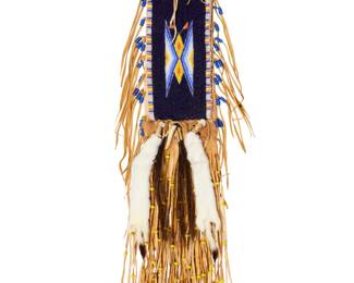 1318 A Cheri Cappello Plains style beaded hide bag Cheri Cappello (b. 20th century) Late 20th/early 21st century Signed in ink verso: Cheri Cappello / CCR A hide or buckskin bag with central beaded panel with geometric motifs in blue, white, and yellow, buckskin fringe with trade-style beads and with antler, animal teeth, horsehair, and ermine pelt accents 40" L x 6.5" W including fringe Estimate: $300 - $500