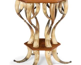 1082 A Contemporary horn and wood side table Mid/late 20th century Constructed from stacked bovine horns, with a hexagonal wood top and undertier 30.375" H x 28" Dia. Estimate: $500 - $700