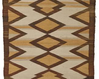 1237 A Navajo regional rug Circa 1930s, Diné Woven in cream, grey, brown, and ochre wools, with central stacked diamonds and sawtooth long edges 57.5" H x 39" W Estimate: $300 - $500