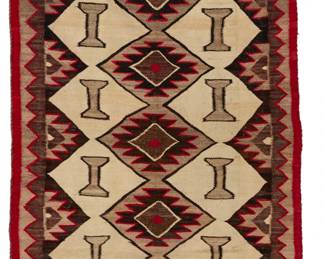 1166 A Navajo regional rug Early 20th century, Diné Woven in red, tan, natural grey, and natural dark brown wool, with stacked serrated diamonds and I-forms within a sawtooth border 65.5" H x 38.5" W Estimate: $500 - $700