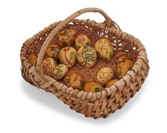 1314 Lester Breininger Jr. (1935-2011, American) A collection of Pennsylvania glazed redware pottery eggs, 1977 & 1981 Seven incised, eight painted with artist's typical marks and variously dated 77 or 81 Comprising seven painted with floral or animal figure motifs, and eight decorated in amorphous yellow and green glazes, all set in a woven basket 15 pieces Larger eggs: 3.5" H x 2.5" Dia.; Basket: 10" H x 15.75" W x 12.5" D Estimate: $200 - $400