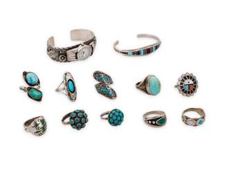 1407 A group of Southwest style jewelry Mid/late 20th century Eight variously marked for maker and/or for sterling: SC / [double-struck indistinct possibly D. Banteah] / MS Mexico [Eagle 107] / Circle J.W. / KG [conjoined] / S^D Comprising a sterling silver watch cuff with intricate silver overlay floral and feather motifs, and a narrow tapered delicate cuff with turquoise, shell, onyx and dark purple stone raised channel inlay and with twisted wire terminals, together with ten silver rings in various styles and sizes including set turquoise, domed cluster set turquoise, chipped mosaic inlay, including one with a peyote bird motif, as well as an oval shadowbox set ring with tiny chipped mosaic accents and a Sunface multistone inlay ring 12 pieces Cuffs each: 6.25" total inner C; 0.75" H & 0.5" H, each gap: 1"; Ring sizes: 9.75 to 6.5 123.5 grams gross Estimate: $200 - $400
