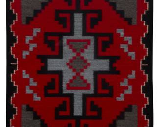 1243 A framed Rena Billie Navajo Ganado textile Rena Billie (b. 20th century, Diné) Circa 1987; Lower Greasewood, AZ A small mat woven in red, grey, and black wool with central hooked diamond and elaborate stepped border to two sides, professionally mounted and framed 16.25" H x 13.125" W Estimate: $100 - $200