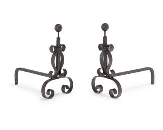 1185 A pair of Spanish Revival style metal andirons 20th century Each with scrollwork and a ball finial 2 pieces Each: 19.5" H x11" W x 21" D Estimate: $200 - $400