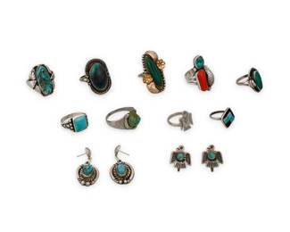 1405 A group of Southwest silver and stone set jewelry Mid/late 20th century Two variously marked for maker and/or for sterling: GFIS Eleven works comprising five rings in various styles and sizes, each with set turquoise, as well as two rings with set malachite, and one ring with set coral and turquoise, together with a diminutive Fred Harvey-style Thunderbird motif stamped silver ring and a pair of matching Thunderbird earrings with set turquoise, and a pair of set turquoise dangle earrings 13 pieces Ring sizes: 12.75 to 5; Earrings: 1.5" H to 0.625" H 77.6 grams gross Estimate: $300 - $500