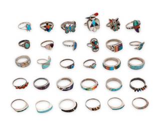 1411 A group of Southwest silver and stone inlay rings Mid/late 20th century Most variously marked for maker and/or for sterling: CLY / MGD / TSI / K / TSP / JCSC S-10 / SS T / Teme [for Sunburst Handcrafts Inc.] / SP / JK / SF Comprising thirty rings in various colors, sizes, and styles, most with stone inlay including turquoise, coral, lapis lazuli, opal, tigers eye, onyx, and mother of pearl, as well as multicolored channel inlay, multicolored cobblestone inlay, and sculptural inlay with onyx and fire opal, together with some Zuni-style rings with figural inlay motifs including woodpecker/Thunderbird, turtle and butterfly 30 pieces Ring sizes: 8 to 3 102.9 grams gross Estimate: $200 - $400