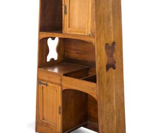 1080 An American oak hoosier style cabinet 20th century Carved with stylized Roycroft orb to one side With upper cabinet and shelf above a single drawer and lower cabinet and opening 71.5" H x 42" W x 17.75" D Estimate: $600 - $800