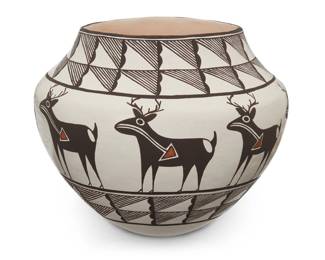 1152 Lucy Lewis (1890-1992, Acoma Pueblo) A polychrome pottery olla and signed book, late 20th century Signed to underside: Lucy M. Lewis. / Acoma The jar depicting heartline deer figures in black and orange on a white slip ground, together with hardcover book: Peterson, Susan. "Lucy M. Lewis, American Indian Potter." New York: Kodansha International, 1984 First Edition, twice Signed by the Artist 2 pieces Olla: 7" H x 8.625" Dia.; Book: 12" H x 9.25" W x 1" D Estimate: $800 - $1,200