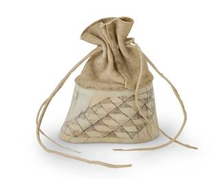 1322 George Blake (b. 1944, Hupa-Yurok) A small carved elk antler freestanding bag, circa 1995-1996 Etched to lower edges on each side: G BLAKE / 3.96 With carved base featuring angled rows of diamond motifs in a traditional 'stairway to heaven' basket design, with a buckskin drawstring top stitched to the top edge 3.75" H x 3.25" W x 1.375" D Estimate: $200 - $300