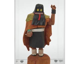 1202 Jeff Tsalabutie (1974-2009, Zuni Pueblo/Hopi-Tewa) A painted carved cottonwood Suyuki ogre katsina, circa 1998 With incised signature, other marks obscured: JEFF TSALABUTIE The Mixed Dance rainmaker ogre, housed in a plastic display case with mirrored back Figure: 7.5" H x 3.75" W x 2.75" D; Case: 9.75" H x 5.5" W x 5.5" D Estimate: $400 - $600