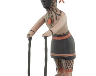 1150 Mary Janice Ortiz (b. 1956, Cochiti Pueblo) A polychrome pottery standing figure, late 20th/early 21st century Signed to underside: M. J. Ortiz / Cochiti, NM Depicted with canes, decorated with black and orange on a cream slip ground, mounted to an enameled metal stand Figure: 12.25" H x 5" W x 7.75" D; Overall: 12.75" H x 5" W x 9.5" D Estimate: $300 - $500
