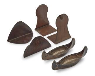 1184 A group of Arts & Crafts metalwork items Late 19th/early 20th century Bookends impressed with Roycroft orb; canoes with English hallmarks for sterling, 1896, and maker: S.I.L.D [Stokes & Ireland; Chester] Comprising two pairs of Roycroft copper bookends and a pair of English sterling models of canoes 6 pieces Taller pair of bookends: 5.25" H x 3.625" W x 3" D; Each canoe: 2.375" H x 7" W x 2" D Total sterling weight: 4.7 oz. troy approximately Estimate: $300 - $500