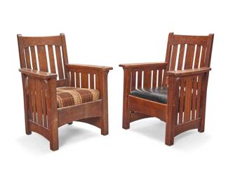 1174 A pair of Limbert oak arm chairs Early 20th century, Grand Rapids, Michigan Burned mark to one: Limbert's Arts and Crafts Furniture / Made in Grand Rapids and Holland Each with slatted back and corbeled flat armrests on slatted supports, with drop-in seat cushion, one later upholstered in a wool plaid fabric, the other upholstered in black leather 2 pieces Each: 39" H x 29.75" W x 28.25" D Estimate: $800 - $1,200