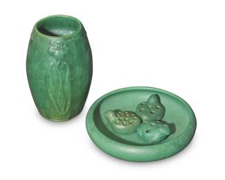1262 A group of five Arts & Crafts matte green glazed pottery items Early 20th century Each unmarked Comprising a Bauer low bowl, three Bauer flower frogs in the form of two birds and one frog, and a Zanesville floral vase 5 pieces Bowl: 2.25" H x 9.5" Dia.; Vase: 8.75" H x 5.75" Dia. Estimate: $200 - $400