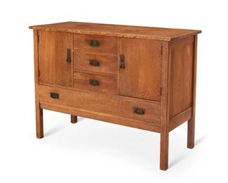 1299 An Arts & Crafts style oak sideboard Late 20th century Unmarked Quarter-sawn with brass lock plates and pulls, comprising three central drawers flanked by two locking cabinet doors above a long drawer 36.25" H x 47.75" W x 20.25" D Estimate: $700 - $900