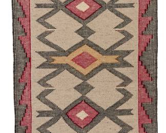 1236  A Navajo raised outline textile Late 20th century, Diné Woven in a raised line weave in grey, red, black, and tan wool with five stacked diamond waterbug motifs and a complex stepped border to two sides 59.5" H x 31" W Estimate: $300 - $500