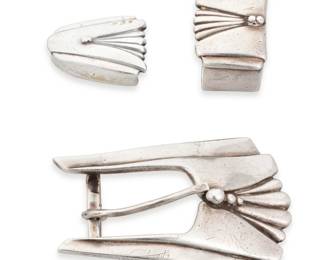 1352 A David Dear 'Fritz" Southwest sterling silver ranger set Late 20th century Buckle stamped: DEAR / .925 / © A 'Fritz' Art Deco-style set comprising a sterling silver buckle, one keeper, and a tip, each with an incised and overlay fan motif with silver dot accents Buckle: 1.75" H x 2.25" W, opening: 0.75"; each keeper: 1" H; tip: 0.75" H 52.8 grams Estimate: $300 - $500