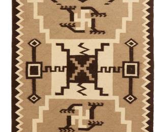 1163 A JB Moore style Storm Pattern textile Mid-20th century, Diné Woven in dark brown, tan, and cream wool, with waterbugs and whirling log motifs, plate XXVIII variation 58.25" H x 41.5" W Estimate: $700 - $900