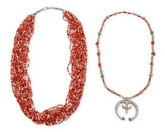 1335 Two Southwest necklaces Mid/late 20th century Comprising a sandcast sterling silver naja suspended by a single strand of coral, heishi, and silver beads (24" L x 2.375" H), as well as a multistrand fine bead coral and white clam shell necklace (30" L) 2 pieces 254.9 grams gross Estimate: $400 - $600