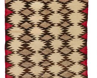 1167 A Navajo regional rug Early 20th century, Diné Woven in red, dark brown, cream, and natural grey/brown wool, with four rows of stacked serrated diamonds 47" H x 32" W Estimate: $300 - $500