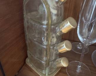 Set with Four Shot Glasses and vintage Garnier Liqueurs four-tiered glass decanter, often referred to as a "Flacon Quadrille". This mid-century modern barware piece, typically made in France