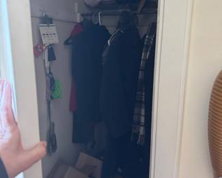 Compact Storage Closet with Shelving and Assorted Items