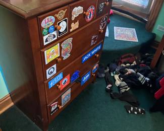 Wooden Dresser with Multiple Stickers and Round Knobs