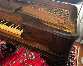 Ornate Victorian-Style Piano with Floral Carvings and Ebony Finish