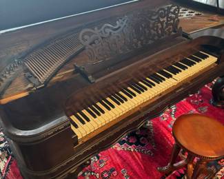 Ornate Black Walnut Parlor Piano with Intricate Carvings