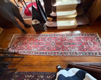 Red floral Persian runner with black and cream borders.