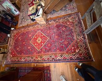 several colorful, patterned rugs