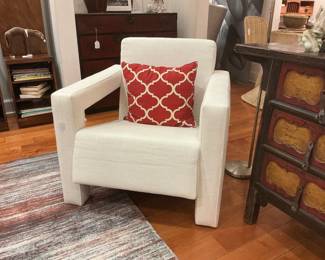 Contemporary pair of ivory architectural club chairs. Features a bold, blocky silhouette and wide square arms upholstered in a textured woven fabric. Clean, minimalist design with a deep-seated profile.