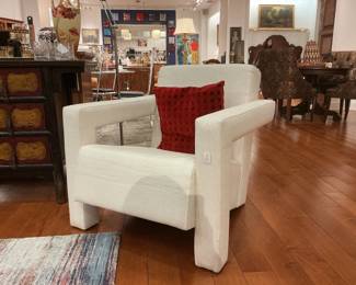 Contemporary pair of ivory architectural club chairs. Features a bold, blocky silhouette and wide square arms upholstered in a textured woven fabric. Clean, minimalist design with a deep-seated profile.