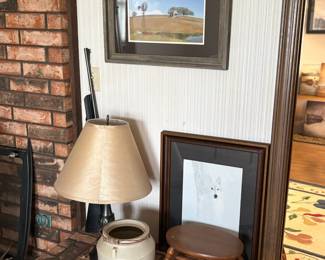 framed photos, small stool, lamp, small crock