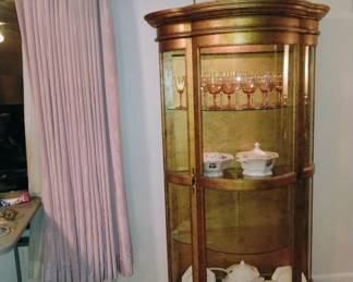 Curio with glassware, wine glasses.