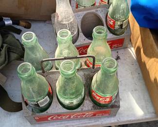 vintage coke bottles and holders