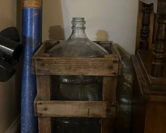 large glass bottle in wood crate