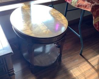 Oval end table with pullout trays.