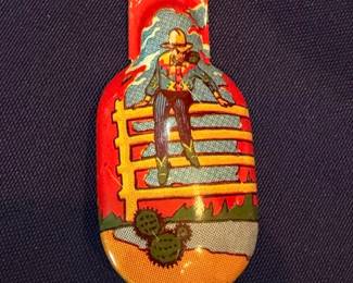 Vintage tin litho cowboy clicker noisemaker toy, Western themed, retro collectible toy
