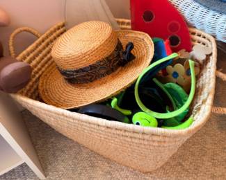 Woven basket with straw hat, vintage toys, stuffed animals, assorted accessories lot