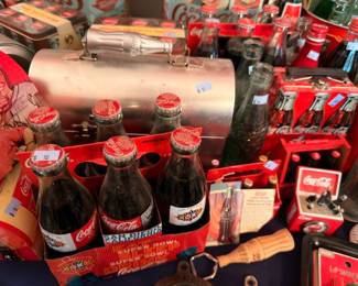 Vintage Coca-Cola glass bottles in red plastic carriers, six-pack Coke bottles collectible