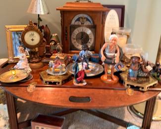 Half-round console table with figurine collection, mantel clocks, decorative collectibles display lot