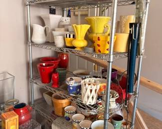 Wire shelf full of pottery vases planters, colorful ceramic kitchenware, mixed lot garden decor
