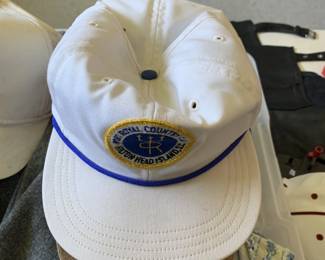 White baseball cap with blue oval emblem patch, vintage golf club hat, promotional cap collectible