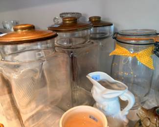 Glass kitchen canisters with copper lids, ceramic creamer, polka dot jar, counter storage lot