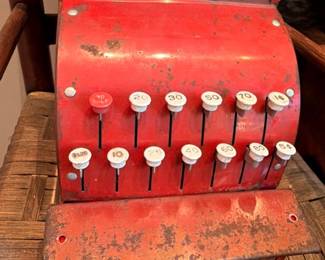 Vintage red metal toy cash register with push buttons, retro toy collectible
