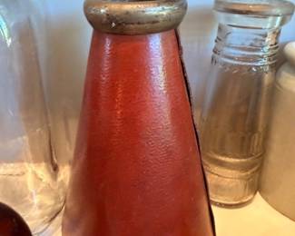 Vintage red glazed ceramic vase with brass rim, antique glass bottles